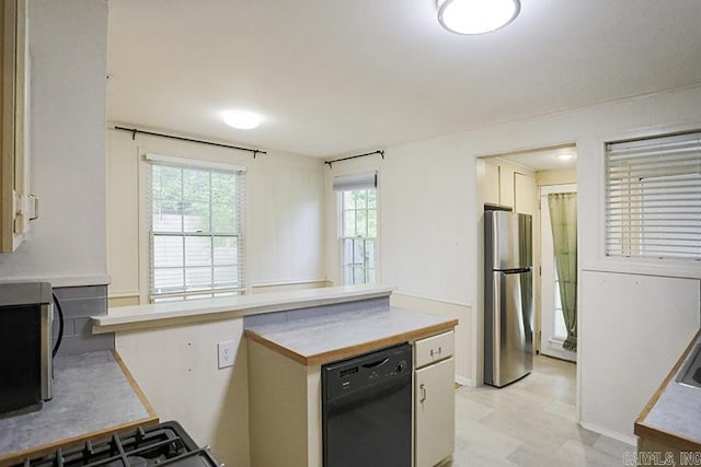 2615 Crouchwood, Little Rock, AR 72207 - kitchen with stainless steel appliances, light countertops, a peninsula, and light floors