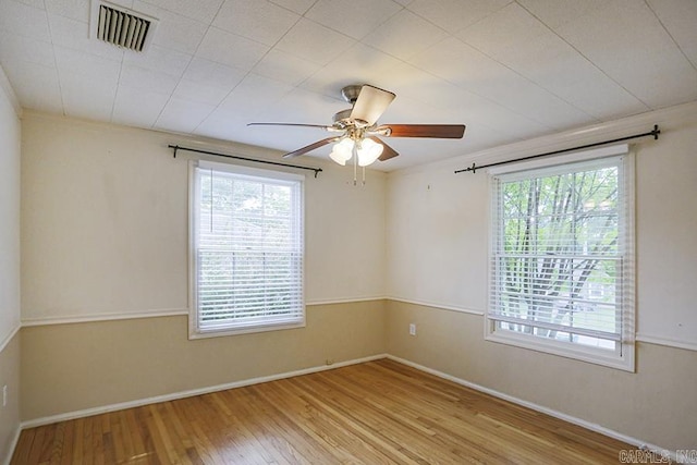 2615 Crouchwood, Little Rock, AR 72207 - empty room with healthy amount of natural light, wood finished floors, and a ceiling fan