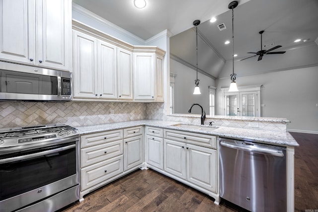 2300 Gordon Rd, Little Rock, AR 72223 - kitchen featuring appliances with stainless steel finishes, ceiling fan, vaulted ceiling, a peninsula, and dark wood-style flooring