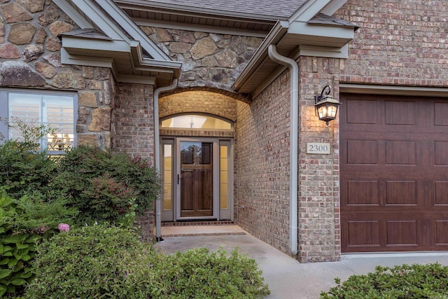 2300 Gordon Rd, Little Rock, AR 72223 - property entrance with stone siding, an attached garage, brick siding, and a shingled roof