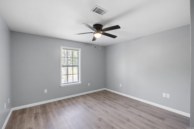 empty room featuring ceiling fan and wood finished floors