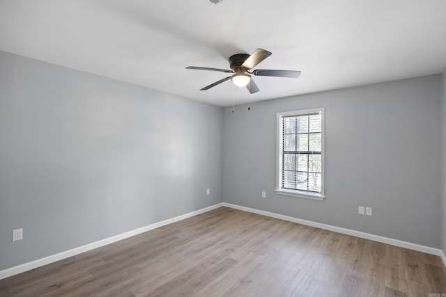 empty room featuring wood finished floors and ceiling fan