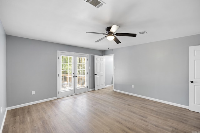 unfurnished room with french doors, ceiling fan, and wood finished floors
