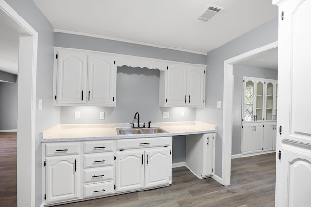 kitchen with white cabinetry, wood finished floors, and light countertops