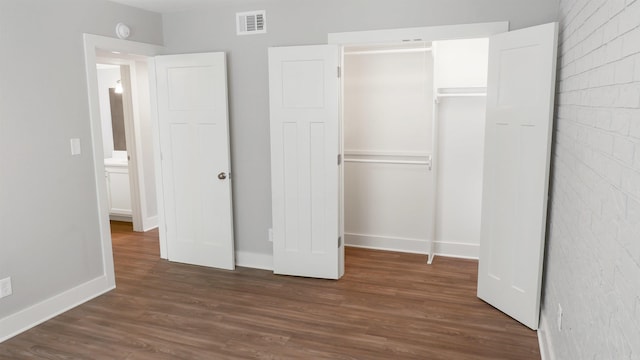 300 W Pleasure Ave, Searcy, AR 72143 - unfurnished bedroom featuring a closet and dark wood-style floors