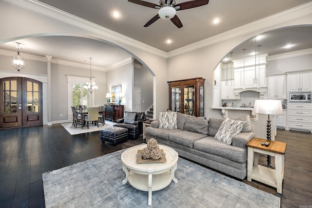 21 Ensbury Pl, Little Rock, AR 72223 - living room featuring stairs, ceiling fan, arched walkways, dark wood finished floors, and a chandelier