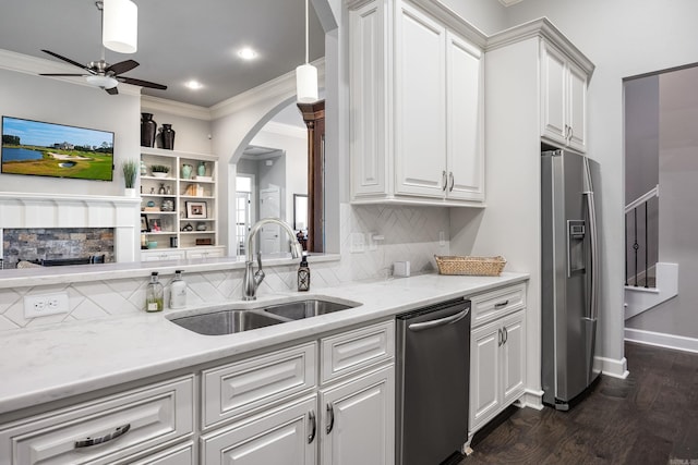 21 Ensbury Pl, Little Rock, AR 72223 - kitchen with appliances with stainless steel finishes, crown molding, a ceiling fan, backsplash, and arched walkways