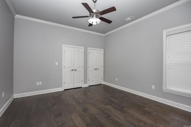 21 Ensbury Pl, Little Rock, AR 72223 - unfurnished bedroom featuring multiple closets, ornamental molding, dark wood-style flooring, and a ceiling fan