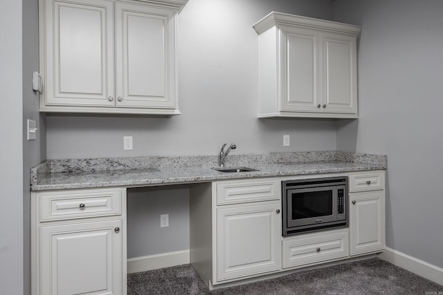 21 Ensbury Pl, Little Rock, AR 72223 - kitchen with stainless steel microwave, carpet, and white cabinets