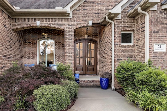 21 Ensbury Pl, Little Rock, AR 72223 - property entrance with french doors, brick siding, and roof with shingles