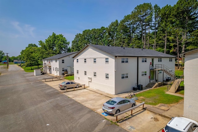 709 Melody Ln, Searcy, AR 72143 - view of property exterior featuring uncovered parking and stairs