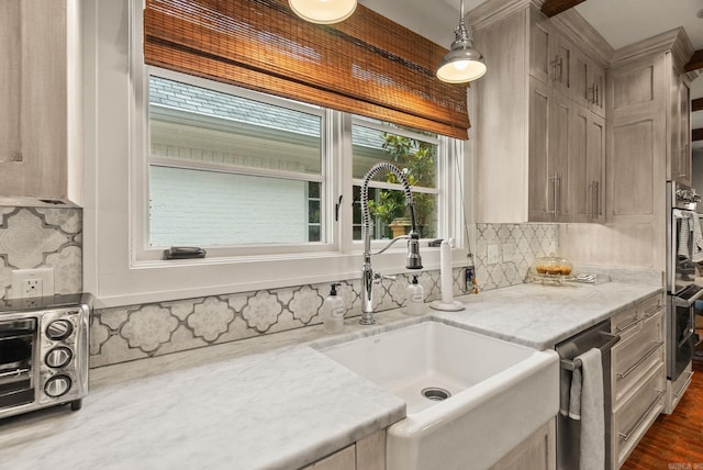 1811 N Jackson St, Little Rock, AR 72207 - kitchen with stainless steel dishwasher, backsplash, pendant lighting, dark wood-style floors, and light stone countertops