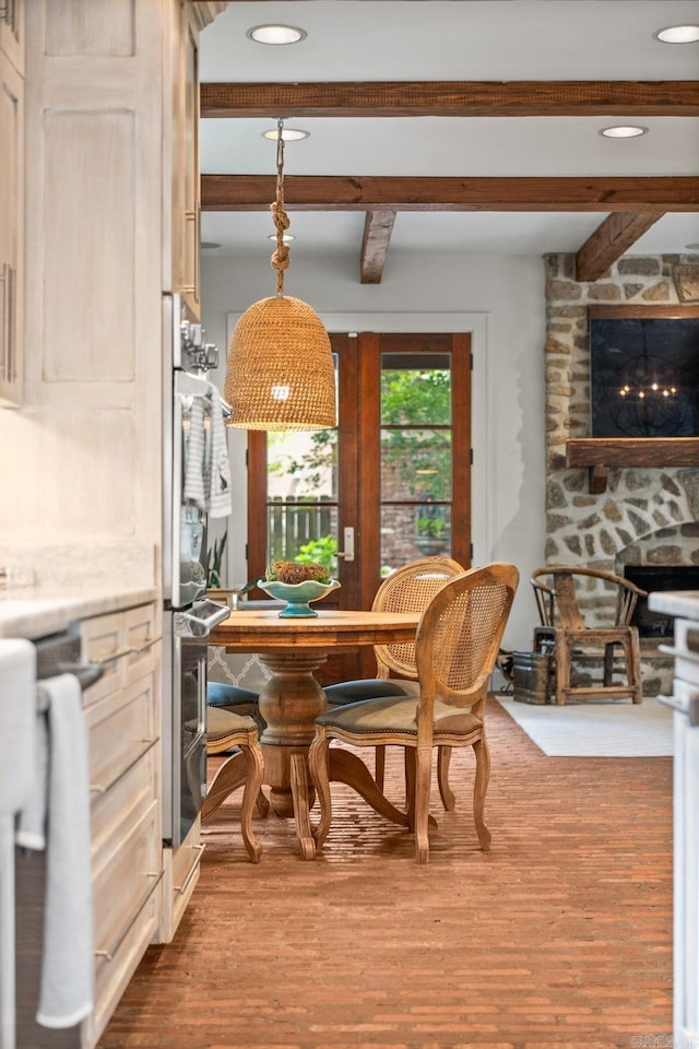 1811 N Jackson St, Little Rock, AR 72207 - dining area with a fireplace, beamed ceiling, dark wood-type flooring, and recessed lighting