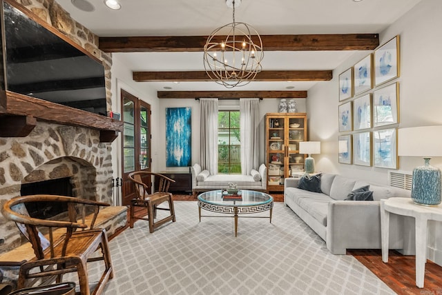 1811 N Jackson St, Little Rock, AR 72207 - living area with wood finished floors, beam ceiling, a stone fireplace, and a chandelier
