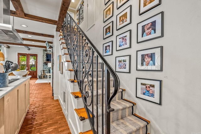 1811 N Jackson St, Little Rock, AR 72207 - staircase featuring beamed ceiling, recessed lighting, and brick flooring
