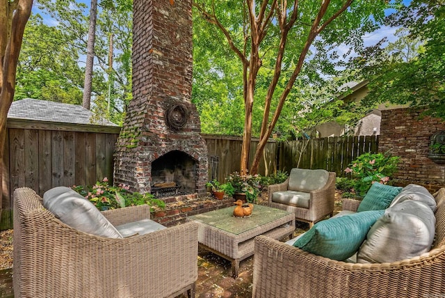 1811 N Jackson St, Little Rock, AR 72207 - fenced backyard with a patio area and an outdoor living space with a fireplace