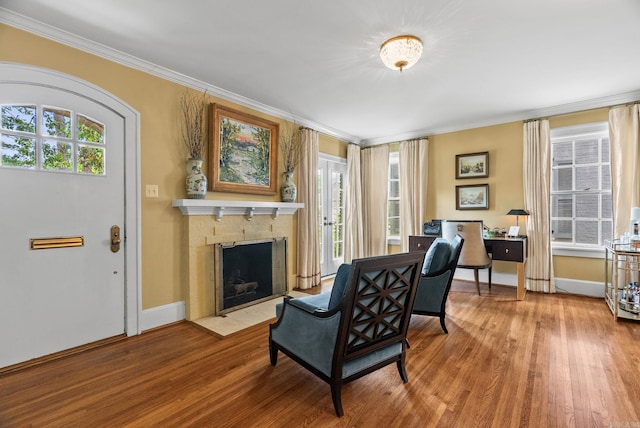 1811 N Jackson St, Little Rock, AR 72207 - living room featuring crown molding, wood finished floors, plenty of natural light, and a fireplace with flush hearth