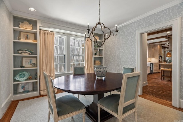 1811 N Jackson St, Little Rock, AR 72207 - dining space with wallpapered walls, wood finished floors, a chandelier, ornamental molding, and built in features