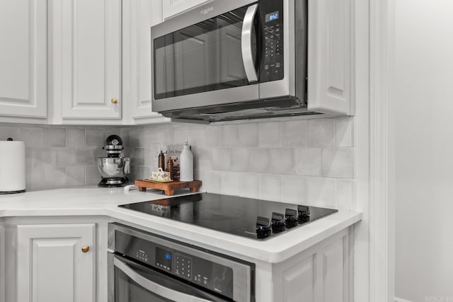 7 Chalamont Way, Little Rock, AR 72223 - kitchen featuring appliances with stainless steel finishes, white cabinetry, tasteful backsplash, and light countertops