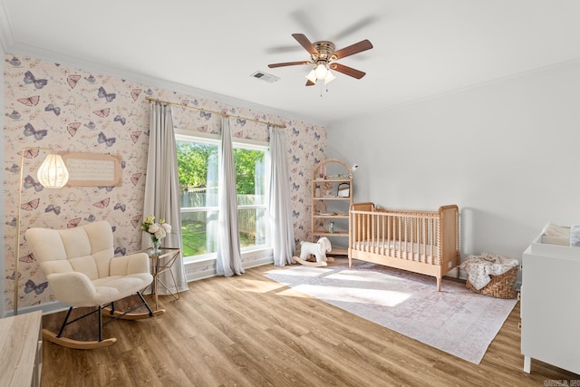 7 Chalamont Way, Little Rock, AR 72223 - bedroom with ornamental molding, wallpapered walls, wood finished floors, a nursery area, and ceiling fan