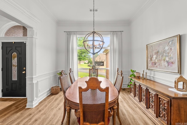 7 Chalamont Way, Little Rock, AR 72223 - dining room featuring a chandelier, light wood-style floors, crown molding, a decorative wall, and a wainscoted wall