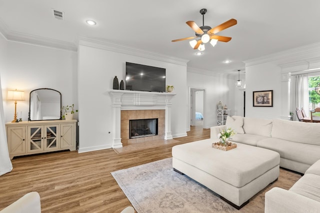 7 Chalamont Way, Little Rock, AR 72223 - living room with a ceiling fan, wood finished floors, crown molding, recessed lighting, and a tile fireplace