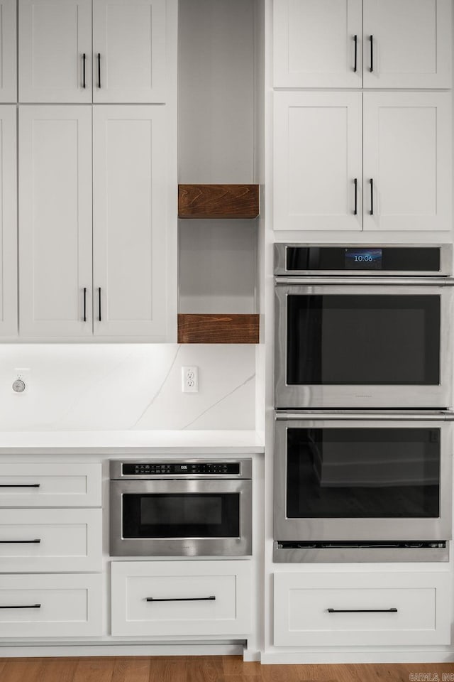 41 Haywood Ct, Little Rock, AR 72223 - kitchen with double oven, white cabinets, light countertops, and open shelves