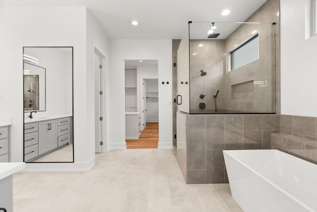 41 Haywood Ct, Little Rock, AR 72223 - bathroom featuring a stall shower, vanity, a freestanding tub, a spacious closet, and recessed lighting