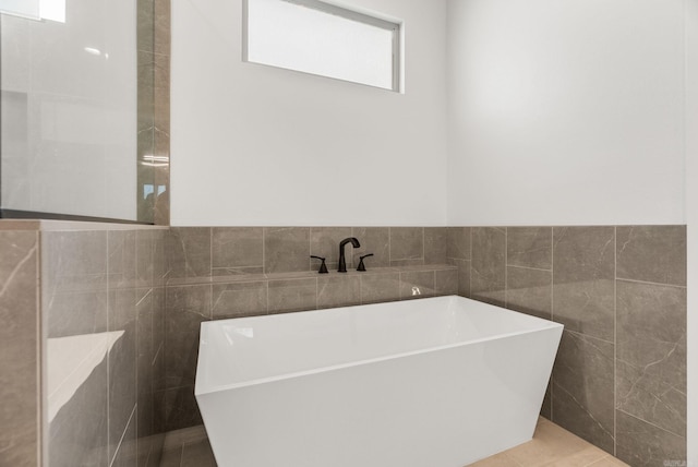 41 Haywood Ct, Little Rock, AR 72223 - full bathroom with tile walls, a freestanding tub, and tile patterned floors