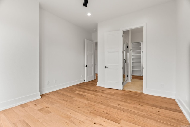41 Haywood Ct, Little Rock, AR 72223 - unfurnished bedroom with a walk in closet, light wood-type flooring, recessed lighting, and ceiling fan