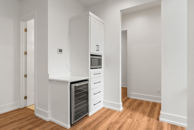 41 Haywood Ct, Little Rock, AR 72223 - bar area featuring wine cooler, light wood finished floors, and stainless steel microwave