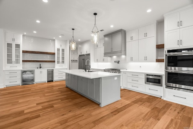 41 Haywood Ct, Little Rock, AR 72223 - kitchen featuring beverage cooler, stainless steel appliances, open shelves, light countertops, and light wood-type flooring
