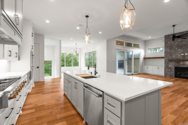 41 Haywood Ct, Little Rock, AR 72223 - kitchen featuring stainless steel appliances, gray cabinets, custom exhaust hood, an island with sink, and ceiling fan