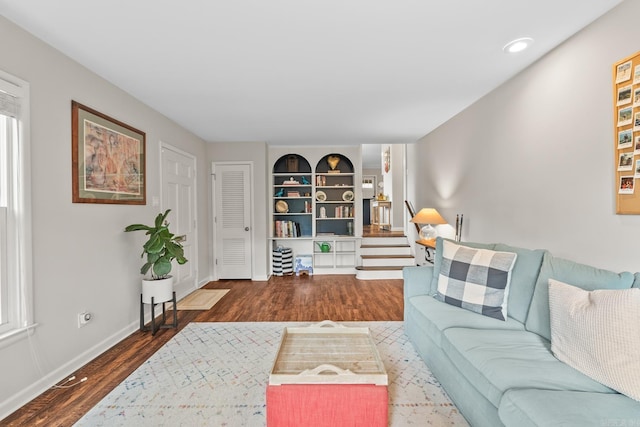7002 Amherst Dr, Little Rock, AR 72205 - living area featuring wood finished floors, built in features, stairway, and recessed lighting