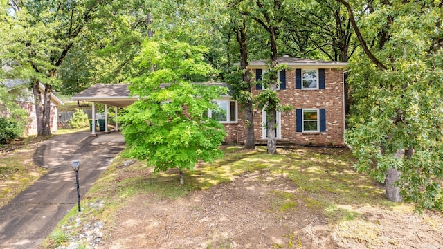7002 Amherst Dr, Little Rock, AR 72205 - colonial inspired home featuring driveway, a carport, and brick siding