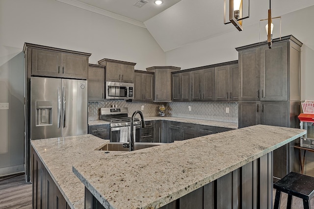 2720 Paradise Hls, Jonesboro, AR 72405 - kitchen with stainless steel appliances, vaulted ceiling, dark brown cabinets, backsplash, and a breakfast bar