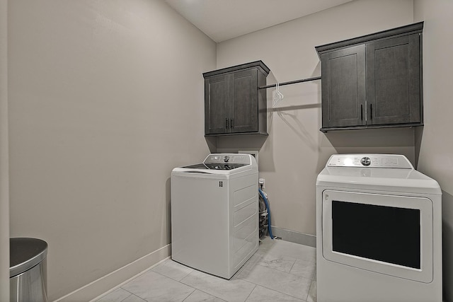 2720 Paradise Hls, Jonesboro, AR 72405 - washroom with washer and clothes dryer, cabinet space, and light marble finish flooring