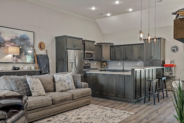 2720 Paradise Hls, Jonesboro, AR 72405 - kitchen featuring open floor plan, appliances with stainless steel finishes, light countertops, crown molding, and light wood-type flooring