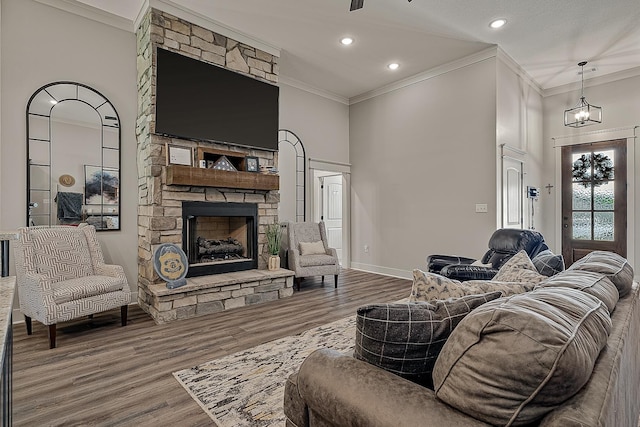 2720 Paradise Hls, Jonesboro, AR 72405 - living area with crown molding, a stone fireplace, wood finished floors, and recessed lighting