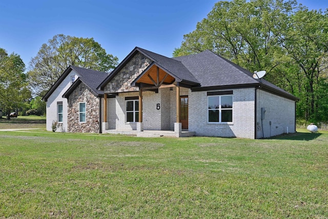 5 Hargrove Rd, Greenbrier, AR 72058 - craftsman-style house with a front yard, brick siding, a shingled roof, and stone siding