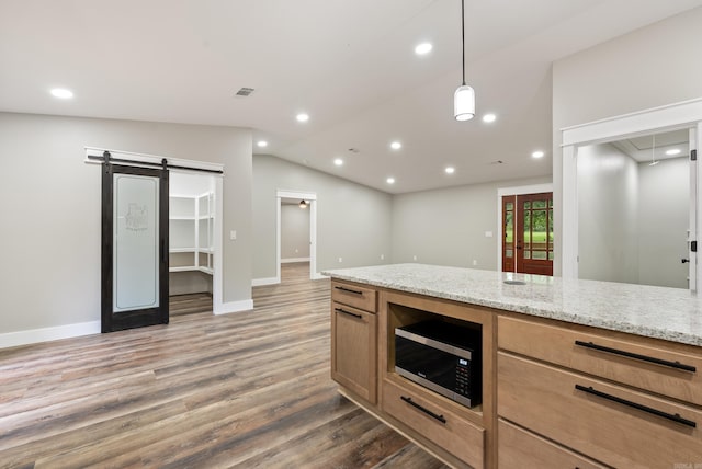 26 W Mobbs Cir, Greenbrier, AR 72058 - kitchen featuring stainless steel microwave, a barn door, wood finished floors, lofted ceiling, and recessed lighting
