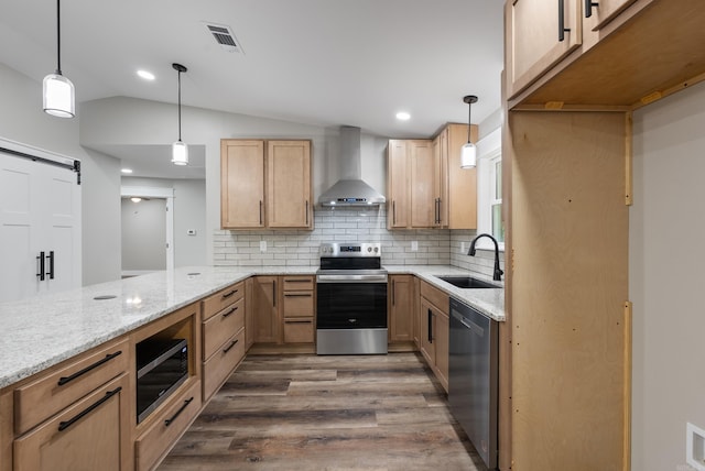 26 W Mobbs Cir, Greenbrier, AR 72058 - kitchen featuring wall chimney exhaust hood, stainless steel appliances, dark wood-style floors, light stone counters, and lofted ceiling