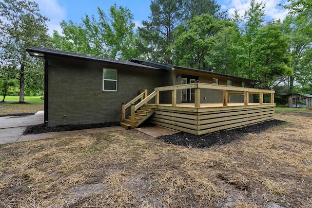 26 W Mobbs Cir, Greenbrier, AR 72058 - back of house featuring a wooden deck and brick siding