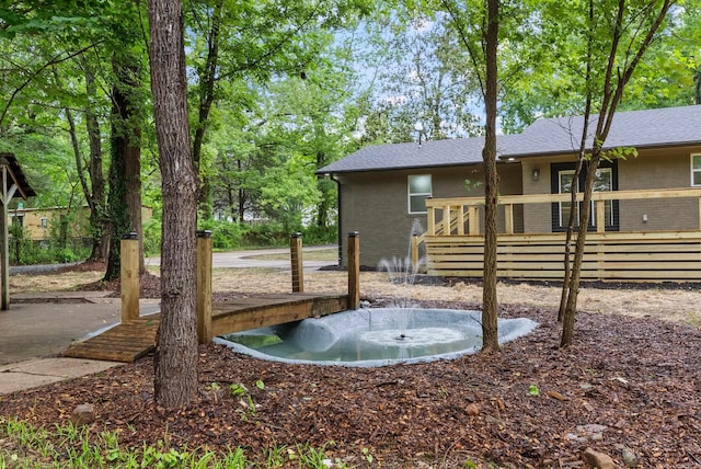 26 W Mobbs Cir, Greenbrier, AR 72058 - rear view of property with brick siding and a wooden deck