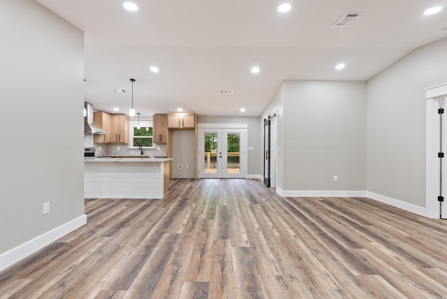 26 W Mobbs Cir, Greenbrier, AR 72058 - kitchen with recessed lighting, decorative backsplash, light wood-style flooring, open floor plan, and french doors