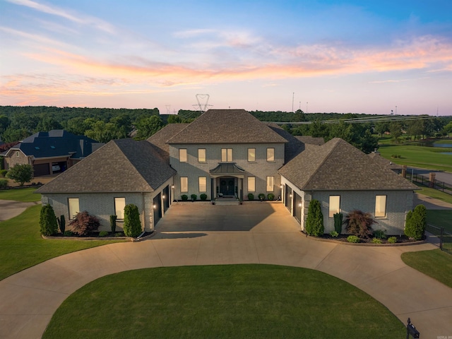 5090 Oakhurst Way, Conway, AR 72034 - view of front facade with curved driveway, an attached garage, a front lawn, and a shingled roof