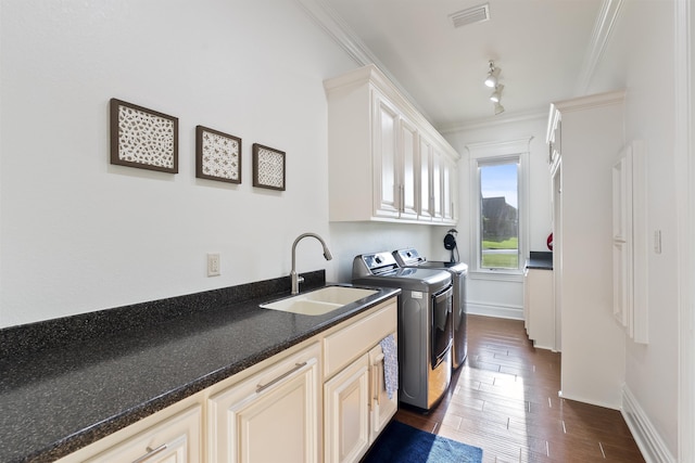 5090 Oakhurst Way, Conway, AR 72034 - washroom with washing machine and clothes dryer, cabinet space, ornamental molding, and dark wood-style floors
