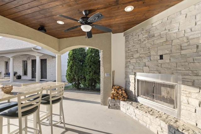 5090 Oakhurst Way, Conway, AR 72034 - view of patio with an outdoor stone fireplace, an outdoor bar, and ceiling fan
