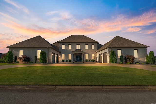 5090 Oakhurst Way, Conway, AR 72034 - view of front of home featuring a garage, curved driveway, a lawn, and brick siding