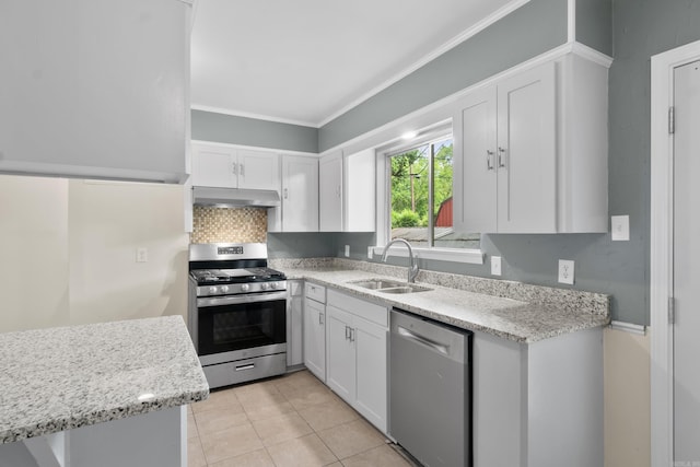 9317 Cynthia Dr, Little Rock, AR 72204 - kitchen with stainless steel appliances, white cabinets, ornamental molding, light tile patterned floors, and under cabinet range hood